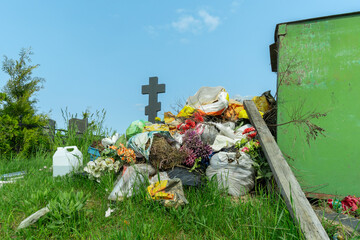 Overflowing Trash Bin at Cemetery. A Silent Witness to Forgotten Memories and Neglect. The...