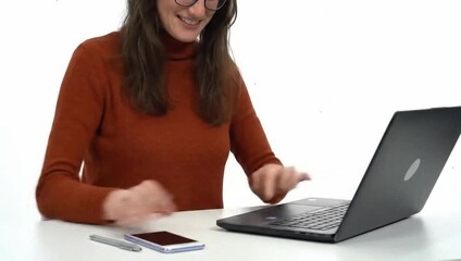 Freelancer working on laptop with minimal desk setup, smiling at camera, isolated on white background - Powered by Adobe