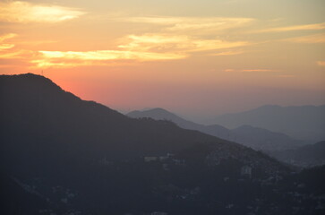 Sunset at night on Rio de Janeiro with city lights and the sea and the mountains