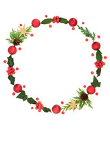 Christmas winter wreath decoration with red gold baubles, nature flora of holly, berries, ivy, cedar fir. Abstract natural design circle symbol for Xmas Season.