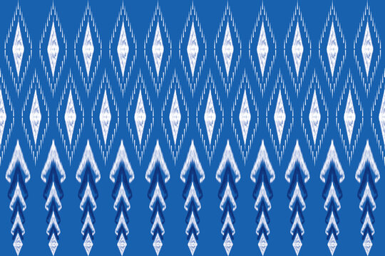 Traditional Blue Ikat Fabric Pattern from Northeastern Thailand. A seamless traditional Thai ikat textile pattern in shades of blue and white, inspired by Northeastern Thai weaving techniques.