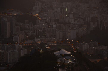 Sunset at night on Rio de Janeiro with city lights and the sea and the mountains