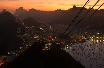 Sunset at night on Rio de Janeiro with city lights and the sea and the mountains