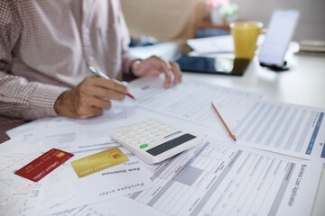 asian men calculating expenses checking bank statement and personal loan from credit card, select...