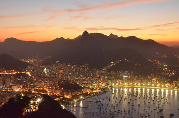 Sunset at night on Rio de Janeiro with city lights and the sea and the mountains