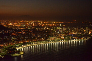 Sunset at night on Rio de Janeiro with city lights and the sea and the mountains