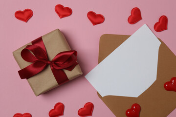 gift box and envelope with space for text on pink background

