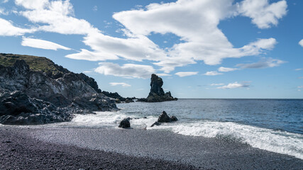 Volcanic lava rocks and rugged coastline at Djupalonssandur beach on Iceland's Snaefellsnes peninsula, within the wild and scenic Snaefellsjokull National Park.