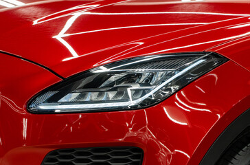 BI-LED headlights of a modern and expensive green car, hood and radiator grille. Front BI-LED...