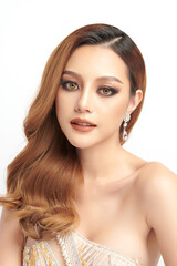 Fototapeta premium A beautiful young Asian woman with clean, fresh skin against a white background. Skincare, facial treatment, cosmetology, beauty, and spa. An elegant portrait of an Asian woman.
