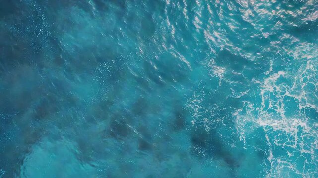 Clear, vibrant blue water in the ocean, with bubbles and light splashes indicating calmness and tranquility.