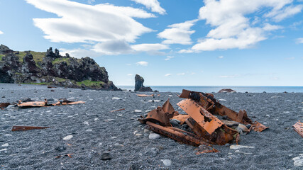 Rusty remains of a shipwreck lie scattered on Djupalonssandur beach, Snaefellsjokull National Park, Iceland.