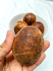 Selective focus. Grilled salted eggs from Brebes in a white bowl. Isolated white background. Duck...
