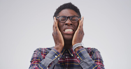 Headache, glasses and upset black man in studio with eye strain for migraine, brain fog and...