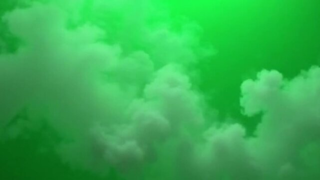 A seamless loop of dense smoke or fog flowing gently over a green screen backdrop, perfect for adding mystery, suspense, or natural elements to any video project through easy compositing.