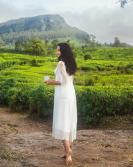 Barefoot Woman Enjoying Tea Among Misty Ceylon Plantation at Dawn