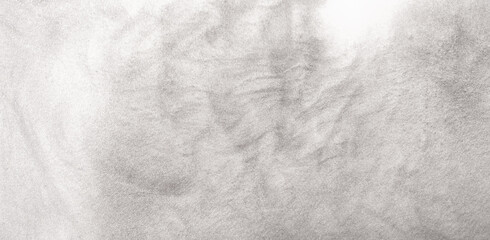 Shimmering silver abstract background. Liquid glitter paint texture waves and swirls. Beautiful shiny white glitter texture. Metallic silver paint close-up as a holiday background.