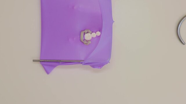 The dentist trains to place a Cofferdam in the mouth using a model of human jaws. Dental equipment. Modern Comfortable dental treatment using a Non-Latex List Insulating shawl. slow motion video. 