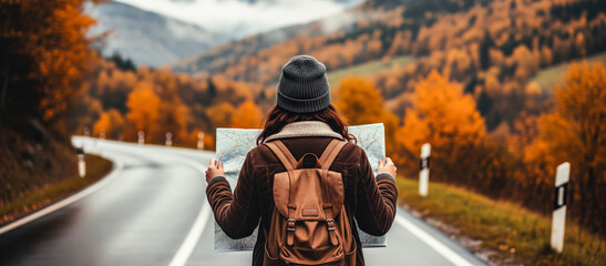 A traveler holding a map explores the vibrant autumn mountains, surrounded by colorful foliage and crisp air. The concept of adventure, navigation, and discovering nature’s beauty. Generative AI.