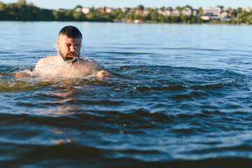 Man drowning in deep blue water of river or lake