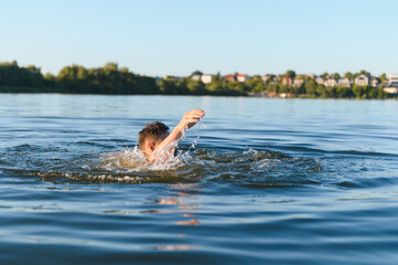 Teenager drowning in a lake during summer vacation