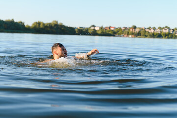 Man drowning in river during summer daytime