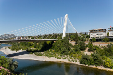 Millennium Bridge crossing Moraca River in Podgorica, Montenegro with modern buildings in background