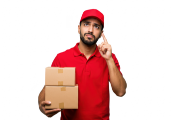 A delivery man in a red uniform and cap thinks with a finger to his temple, holding packages, isolated on white isolated on transparent background