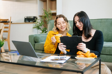 Explore vibrant teamwork, creativity, and learning with young adults using laptops and headphones...
