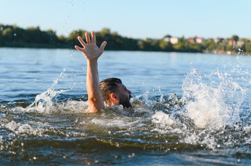 Man drowning in water, reaching for help