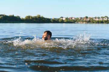 Man drowning in river during summer daytime