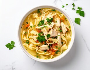Bowl of hearty chicken noodle soup with vegetables and fresh herbs on a white marble surface