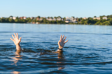 Man drowning in water, reaching for help
