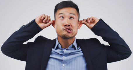 Silly man, goofy and funny face with ears in studio for monkey business on a white background. Male...