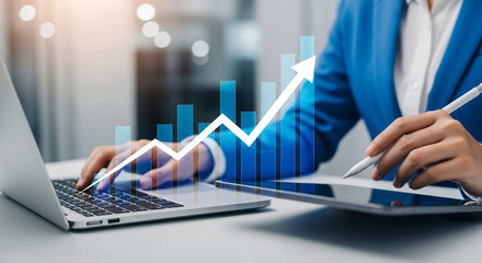 Businesswoman analyzing growth chart on laptop and digital tablet