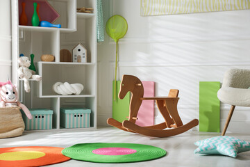 Stylish playroom with toys and furniture. Interior design