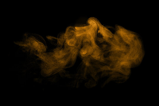 Glitter gold dust on a black background. storm particles of dirt flying, fine sand cloud, abstract. texture of the wind of smoke powder in the desert, causing a wave of brown dust to blow
