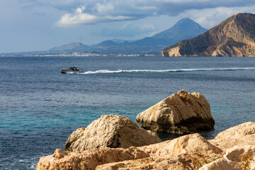 Personal Watercraft leisure activities, Motor boat cruising on calm sea water during the day, with...