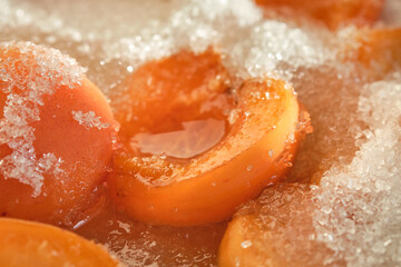 Cooking apricot confiture with sugar. Shallow depth of field. Focus on a center frame