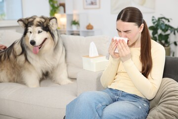 Woman suffering from allergy with her dog at home