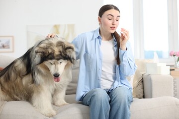 Woman suffering from allergy with her dog at home