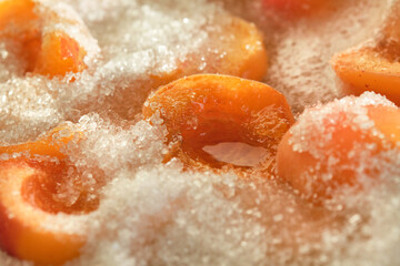 Cooking apricot jam with sugar. Shallow depth of field. Focus on a center frame