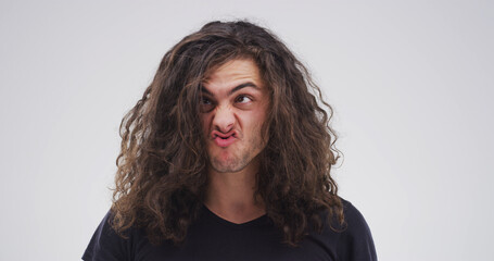 Silly, crazy and man in studio with funny face for playful, comedy and humor on white background....