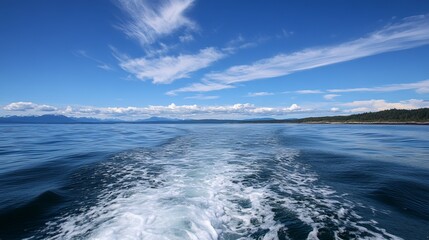 Fototapeta premium Ocean vista, wake of a boat, bright sky, tranquil