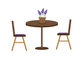 A one-legged table and chairs in a cozy cafe. Lilac flowers in a pot.