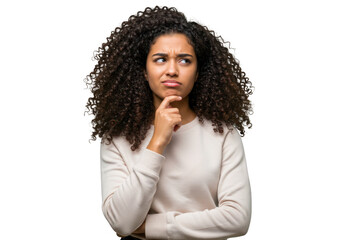 A young woman with curly hair touches her chin thoughtfully, contemplating a difficult question isolated on transparent background