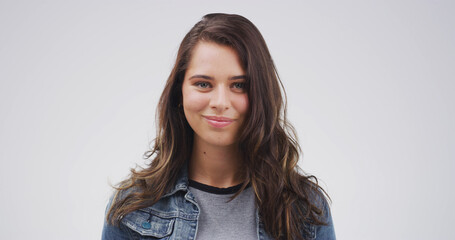 Fototapeta premium Student, woman and smile for education, portrait and confident for studies in university and studio. Happy, pupil and person with pride for skill development in college, white background and USA