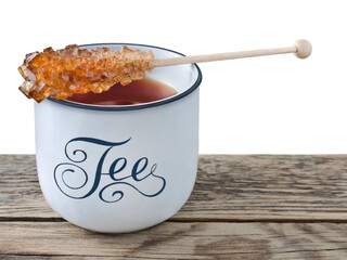 Black Tea and cup with rock sugar isolated on white background