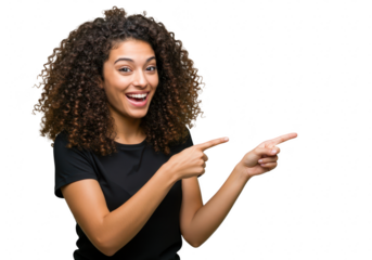 A young woman with voluminous curly dark hair, wearing a black tshirt, joyfully pointing to the side with both index fingers, isolated on white isolated on transparent background