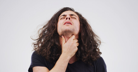 Man, sore throat and virus with pain in studio, frustrated or exhausted with flu on white...